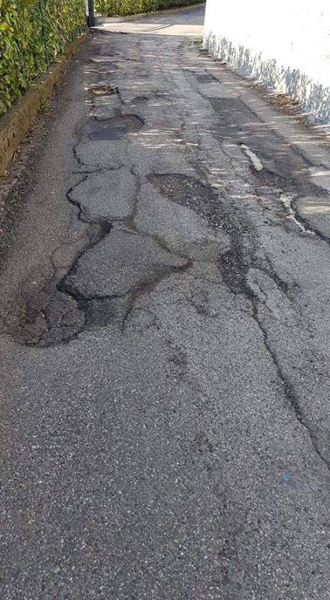 Le segnalazioni dei lettori: asfalto rotto e buche in via Artaria a Monte OLimpino